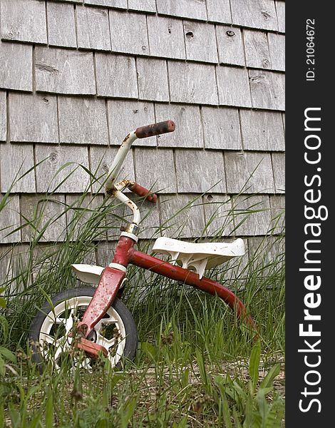 Broken down bike beside a wall of an old house. Broken down bike beside a wall of an old house