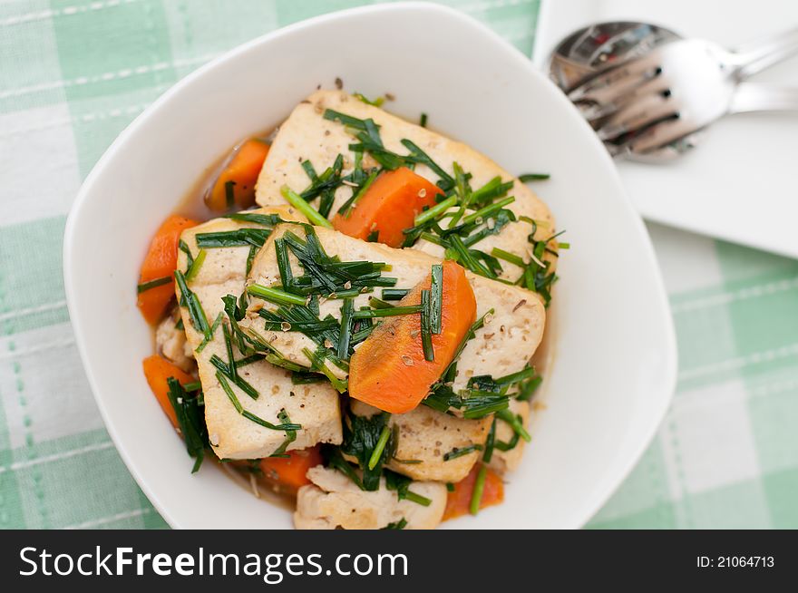 Oriental style stir fried tofu delicacy topped with carrots and spring onion oil. Oriental style stir fried tofu delicacy topped with carrots and spring onion oil.