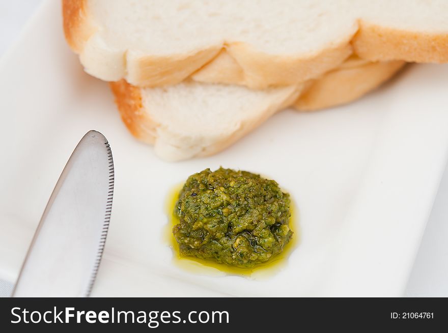 Macro shot of green pesto bread spread at breakfast. Macro shot of green pesto bread spread at breakfast.