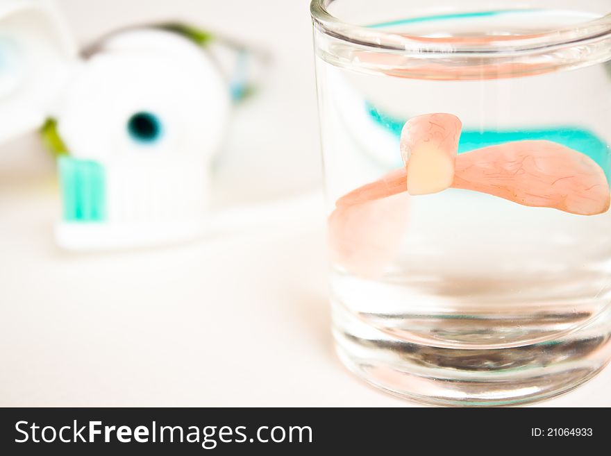 A artificial tooth in water glass