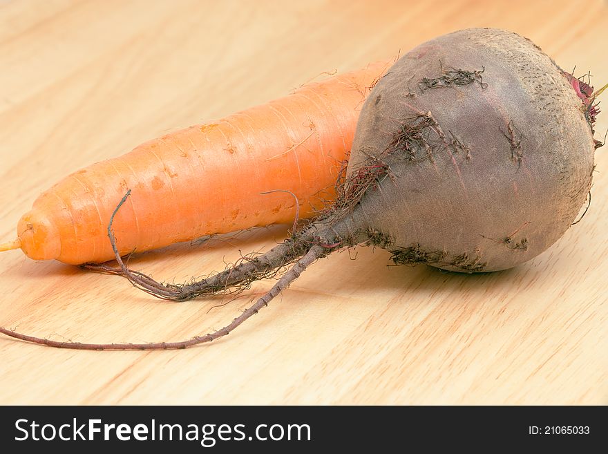 Carrots And Beet On A Wooden Background