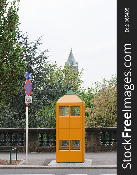 Phone Booth on the background of the spire of the tower in Luxembourg. Phone Booth on the background of the spire of the tower in Luxembourg