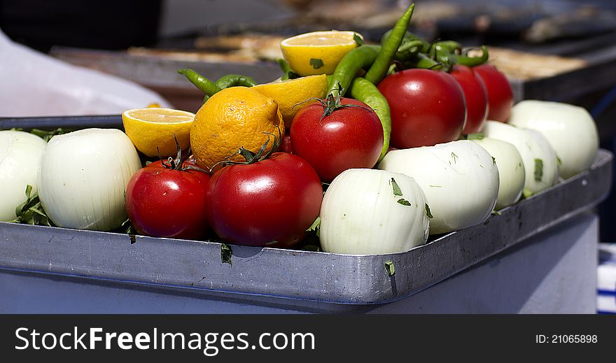 Vegetables on a tray with fish on the background