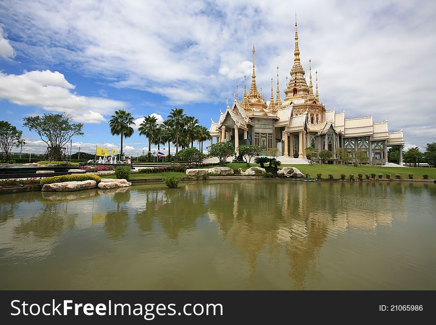 Beautiful Lanscape of White Thai Temple near the pond with reflection and nice sky at Sorapong's Temple in Nakorn Ratchasima Province, Thailand. Beautiful Lanscape of White Thai Temple near the pond with reflection and nice sky at Sorapong's Temple in Nakorn Ratchasima Province, Thailand