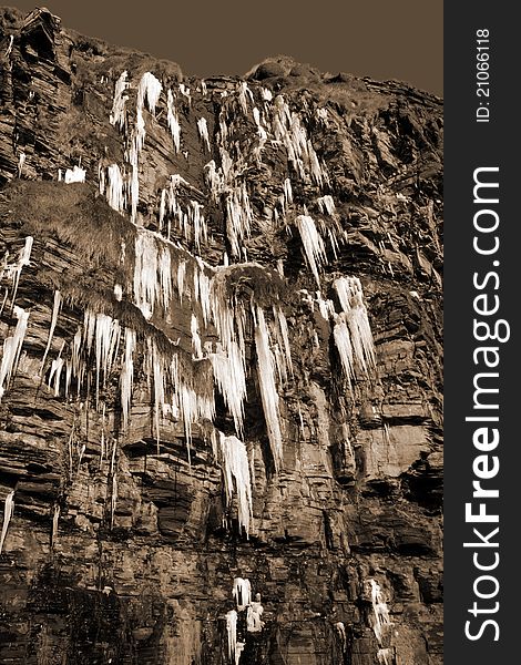 Cascade Of Icicles On A Cliff Face In Sepia