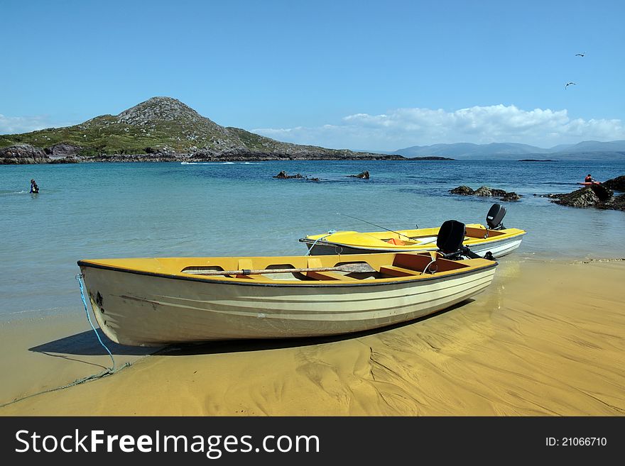 Yellow boats on golden irish beach