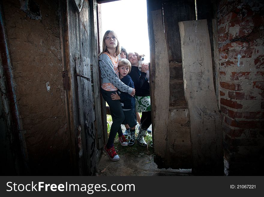 Four kids with frightened fcaces at the door of abandoned house. Four kids with frightened fcaces at the door of abandoned house