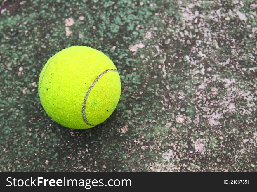 Old tennis ball on grunge dirty floor. Old tennis ball on grunge dirty floor