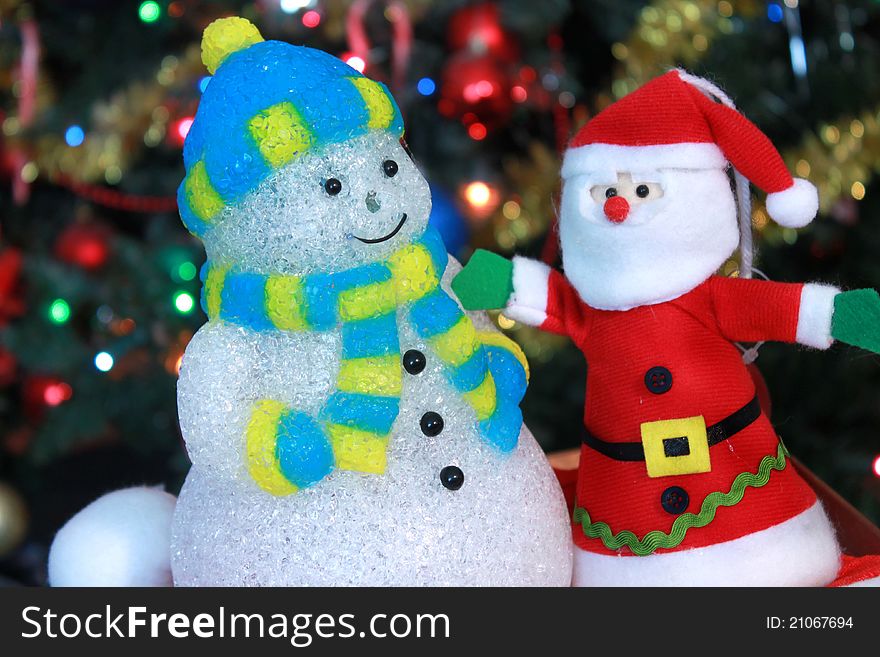 Santa claus and snowman decorations under Christmas tree