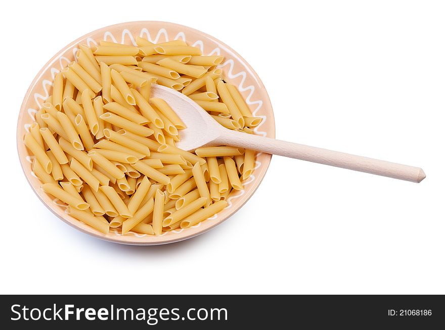 Plate with raw pasta and wooden spoon on white background. Plate with raw pasta and wooden spoon on white background.