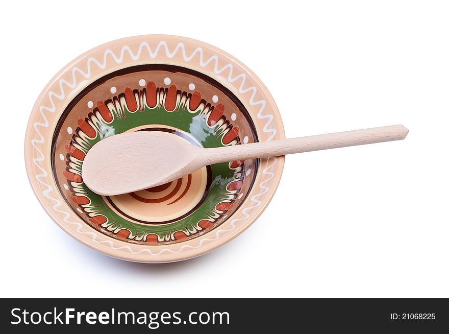 Empty plate with ornaments and wooden spoon. National cuisine. Empty plate with ornaments and wooden spoon. National cuisine.