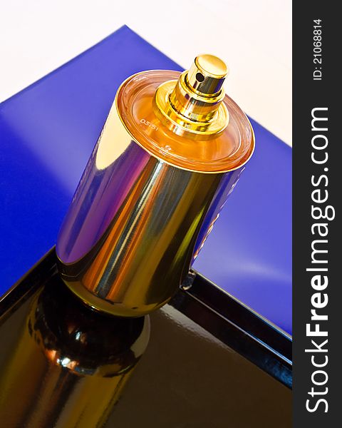 Perfume bottle against colorful background.