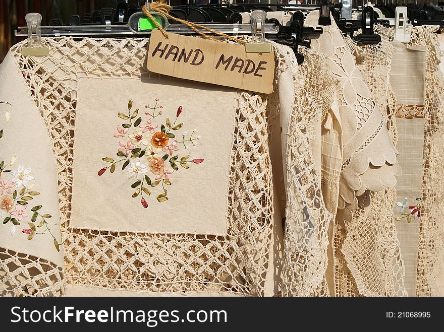 Hand made labelled table cloths decorated with needle-work on a handicraft market. Hand made labelled table cloths decorated with needle-work on a handicraft market