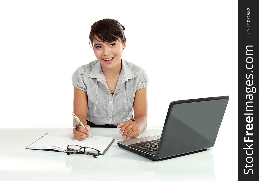 Young business woman working with laptop. isolated over white background. Young business woman working with laptop. isolated over white background