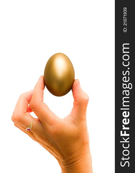 Womans hand holding a golden egg that symbolize knowlegde and fortune. . Womans hand holding a golden egg that symbolize knowlegde and fortune.