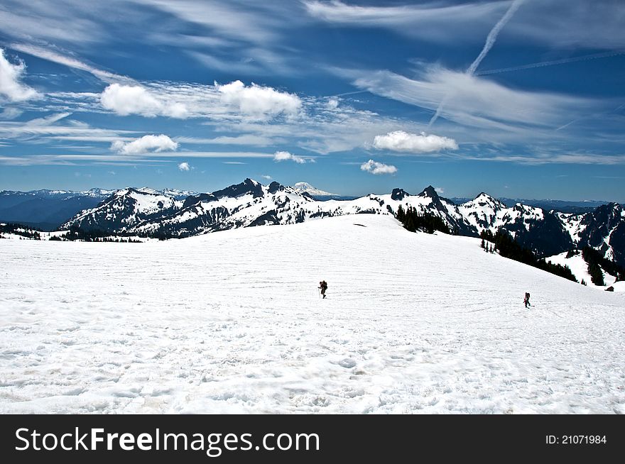 Hikers slowly climbing up Mount Rainier on the way to Camp Muir, base camp for summiting the majestic mountain. Hikers slowly climbing up Mount Rainier on the way to Camp Muir, base camp for summiting the majestic mountain.