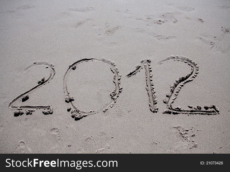 New year 2012 on the beach written on the sand