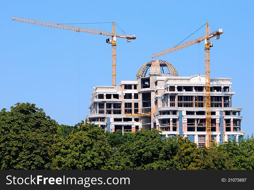 Construction site with cranes and blue sky