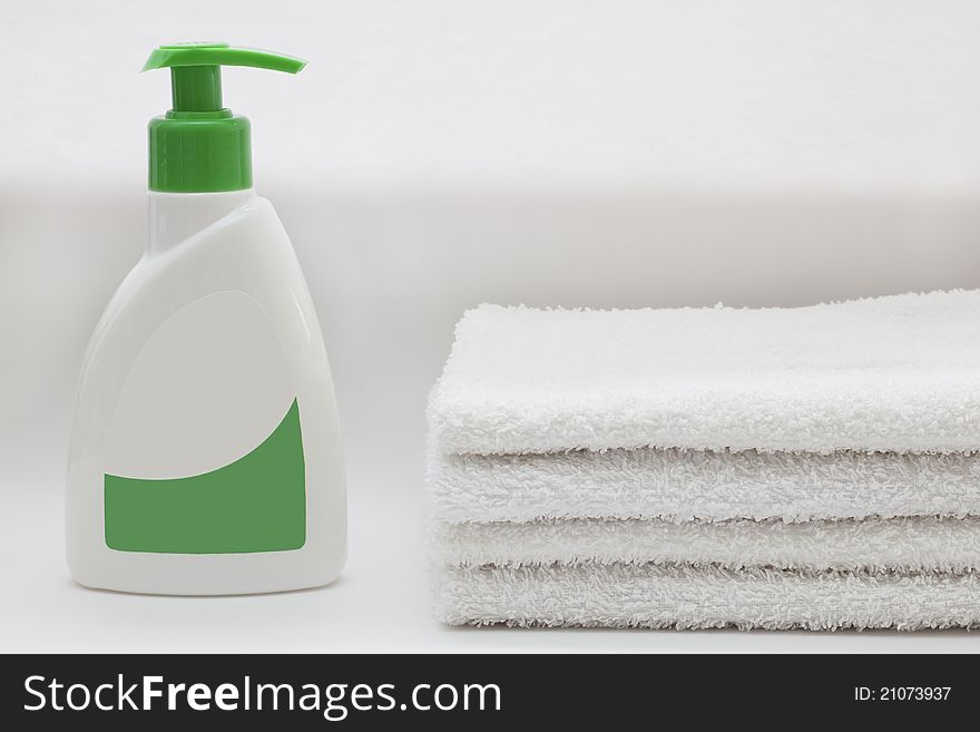 Liquid soap and towels on white. Liquid soap and towels on white