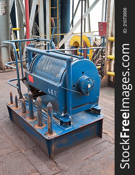 An auxiliary hoist on the rig floor of a drill ship used in the course of drilling operations. An auxiliary hoist on the rig floor of a drill ship used in the course of drilling operations.