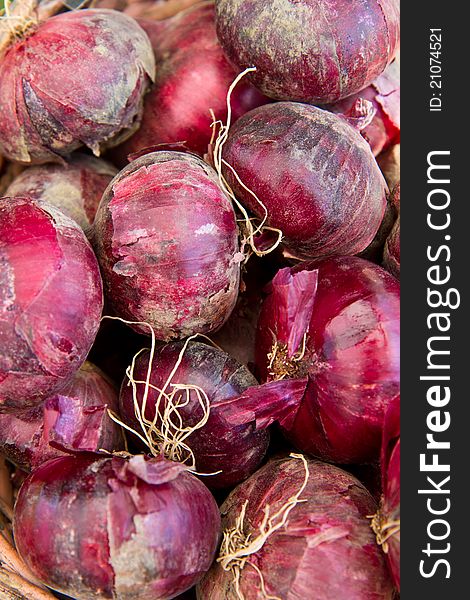 Red onions in a basket for sale at a farmer's market