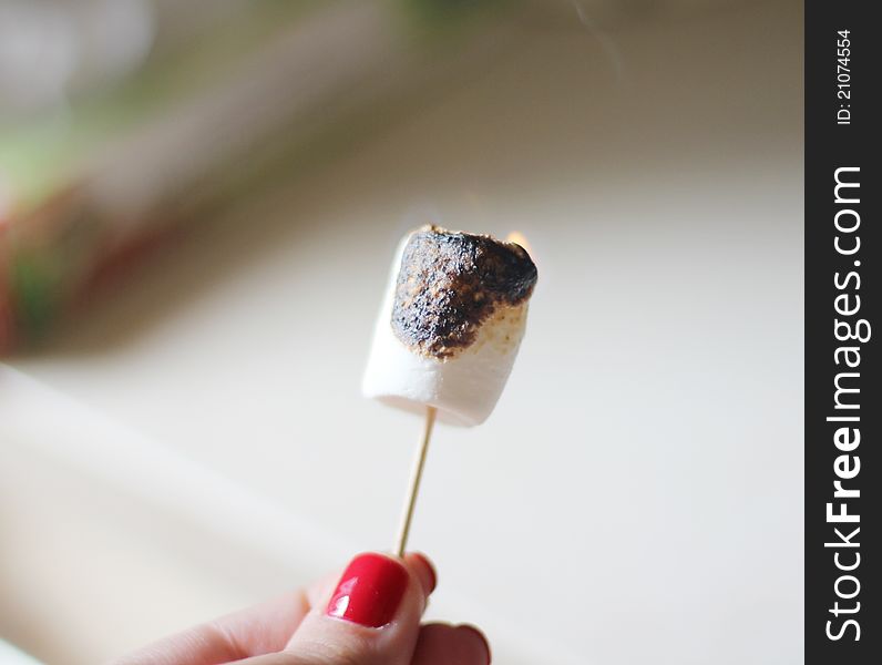 Burning marshmallow in the hand