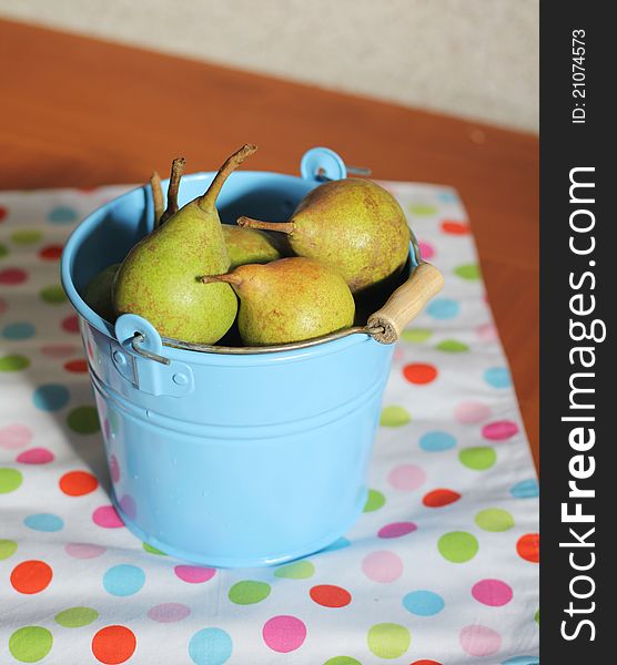 Ripe pears in the blue bucket. Ripe pears in the blue bucket