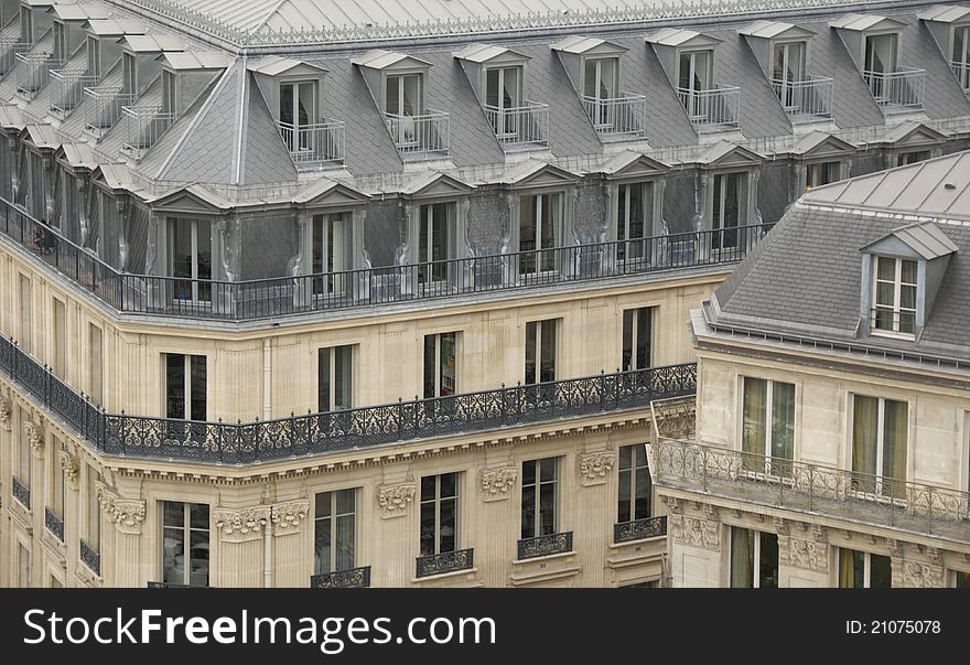 Detail of residential buildings downtown Paris, with characteristic roofs and balconies. Detail of residential buildings downtown Paris, with characteristic roofs and balconies