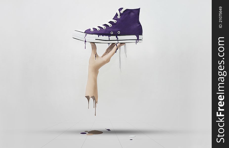 A hand holding a purple sneaker, melted all over the floor. A hand holding a purple sneaker, melted all over the floor.