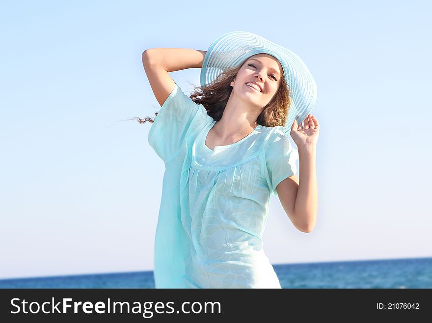 Young beautiful woman on sea background