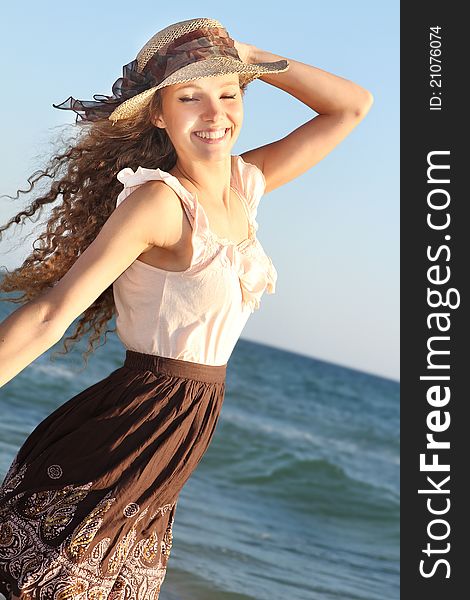 Young happy woman on sea background