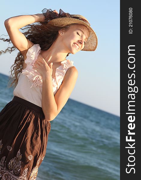 Young happy woman on sea background