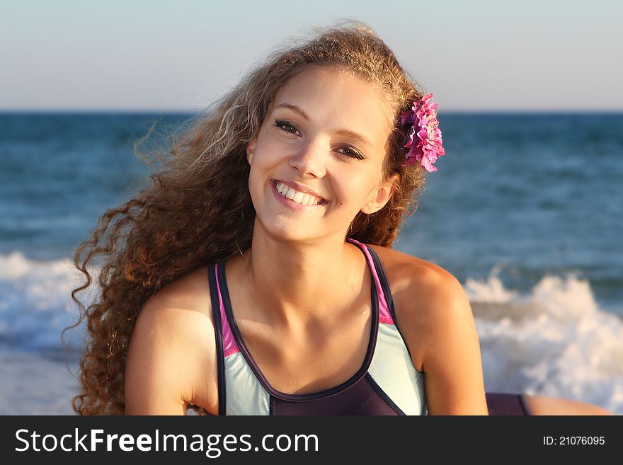 Young smiling woman on sea background