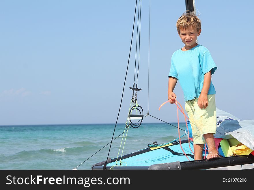 Boy on board of sea catamaran