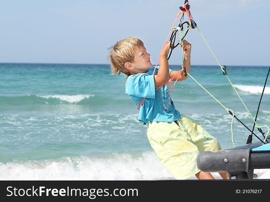 Boy On Board Of Sea Catamaran