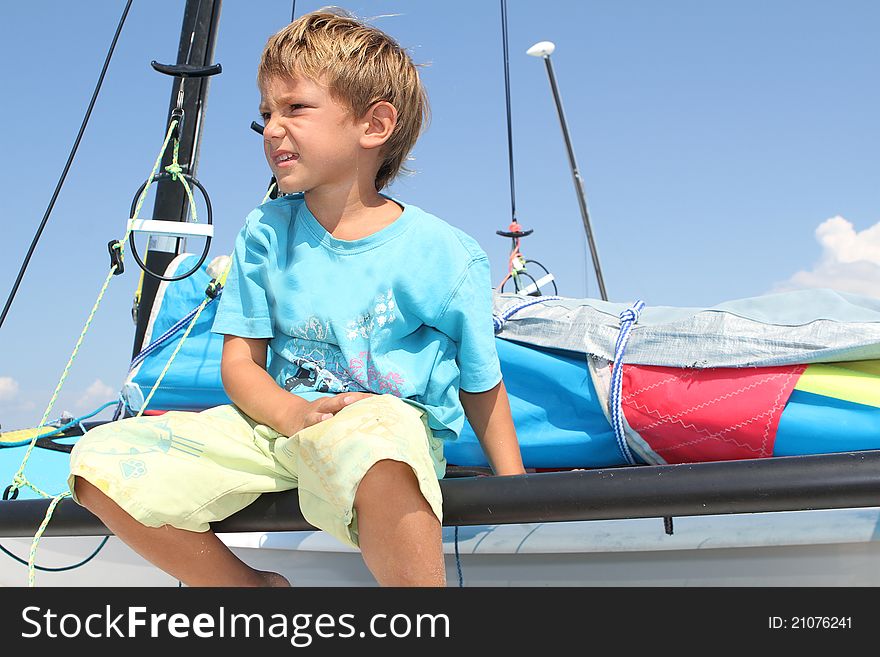Boy on board of sea catamaran