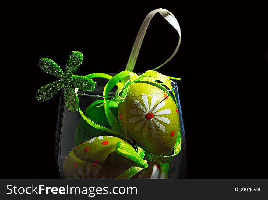 Easter eggs in a glass isolated on black