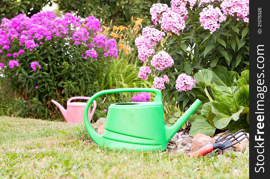 Two watering cans for watering is in the garden