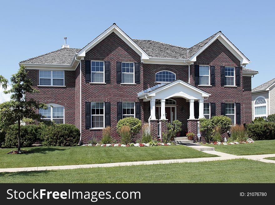 Large brick home with white arched entry. Large brick home with white arched entry