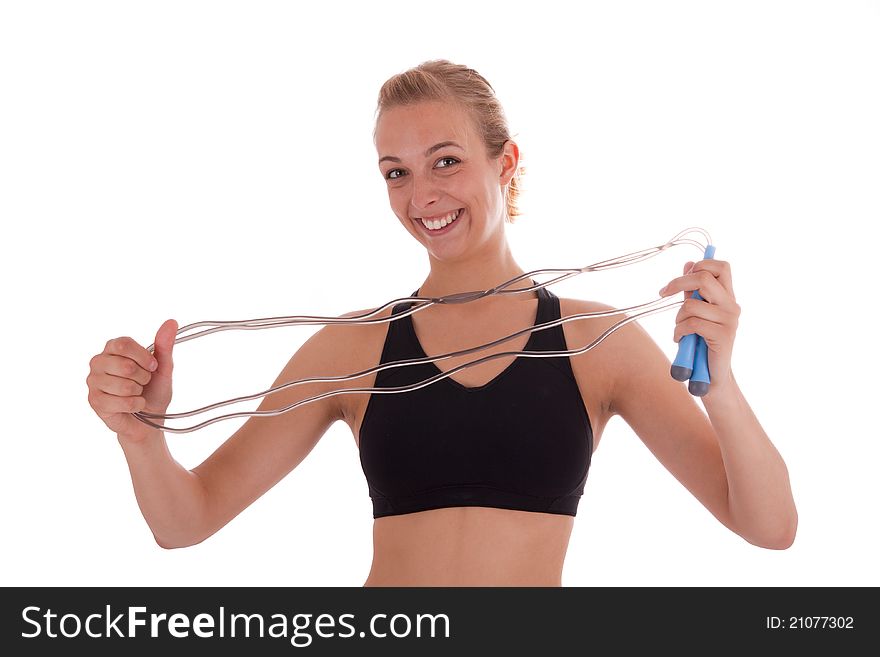 A young beautiful girl with a skipping rope in her hand. A young beautiful girl with a skipping rope in her hand