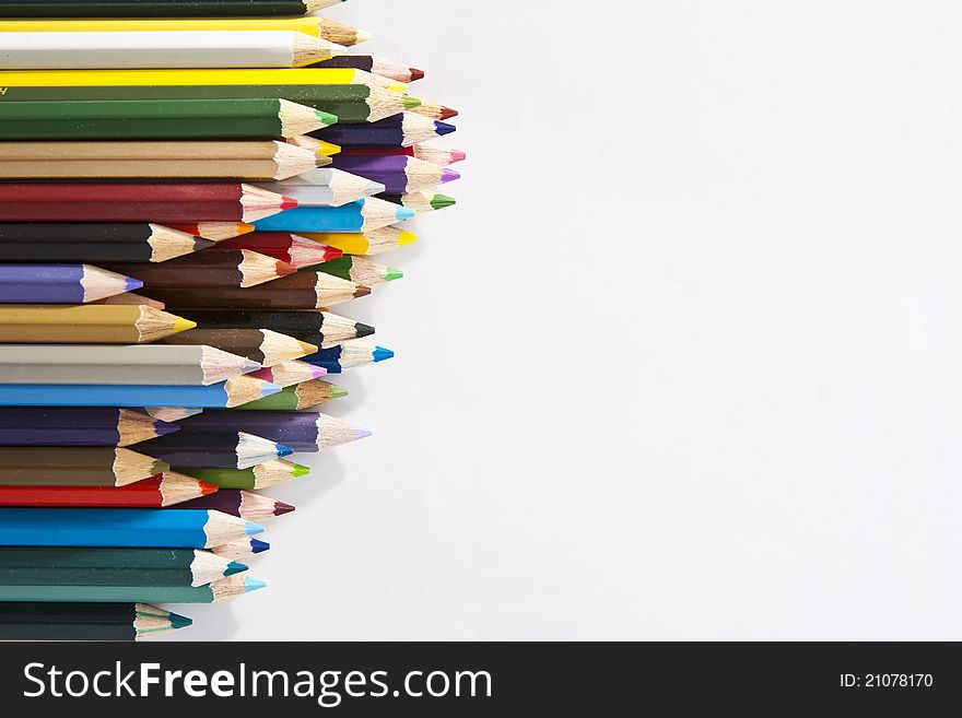 Colorful pencils on left side white isolated background