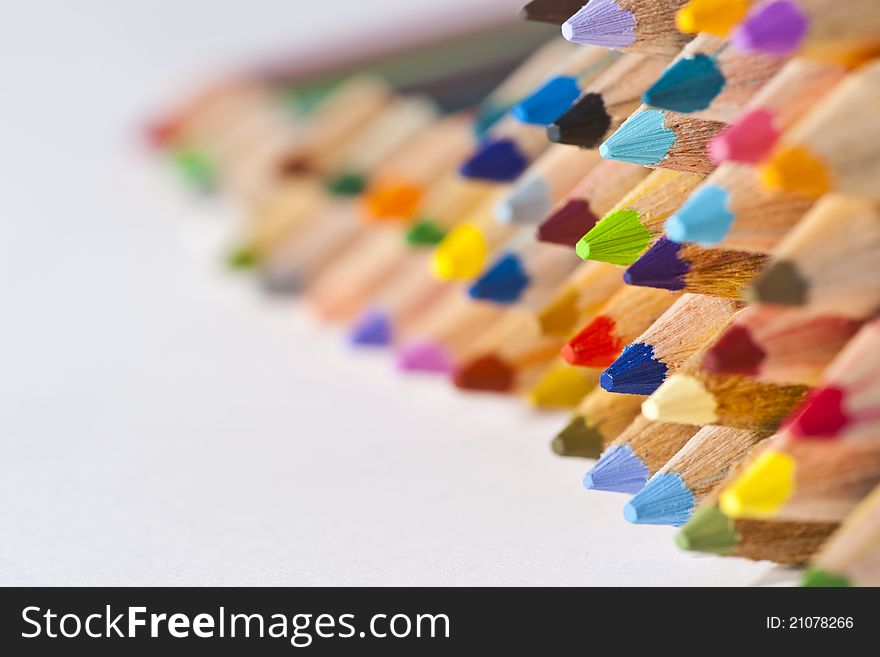 Colorful pencils on right side white isolated background
