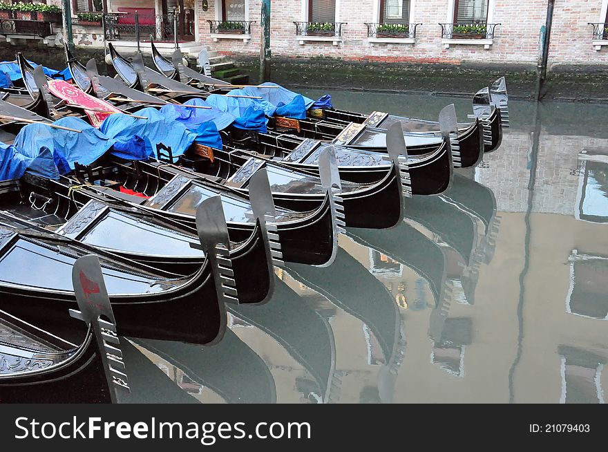 Gondolas parked on the canal in Venice. Gondolas parked on the canal in Venice.