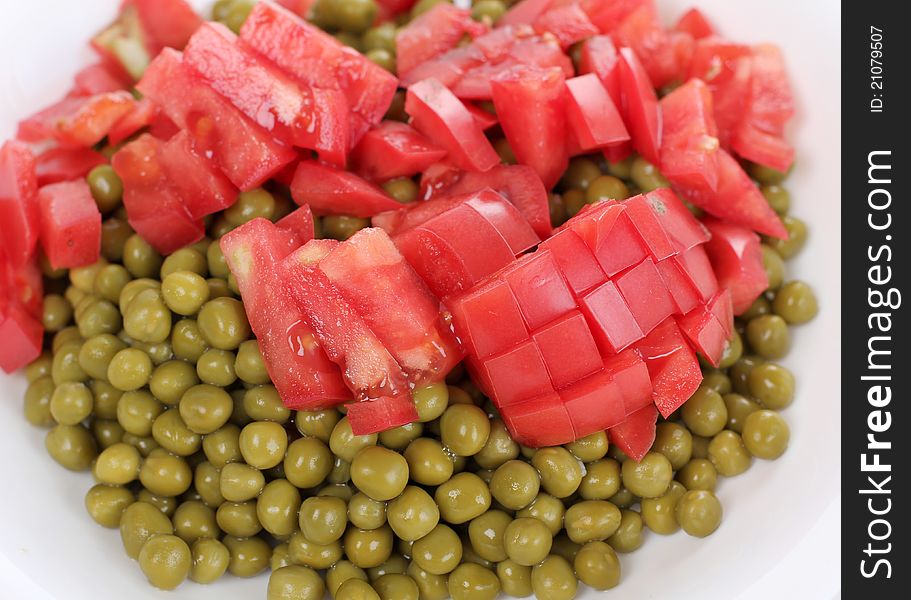 Color photograph of green peas and tomato. Color photograph of green peas and tomato