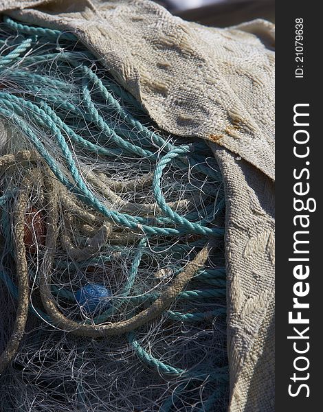 A pile of fishingnets and ropes covered