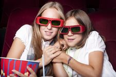 Two Beautiful Girls Watching A Movie At The Cinema Two Beautiful Girls Watching A Movie At The Cinema