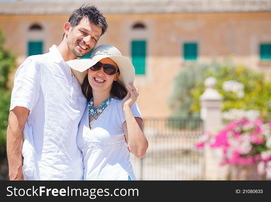 Closeup portrait of happy couple standing in front of the villa. Mallorca. Spain. Closeup portrait of happy couple standing in front of the villa. Mallorca. Spain