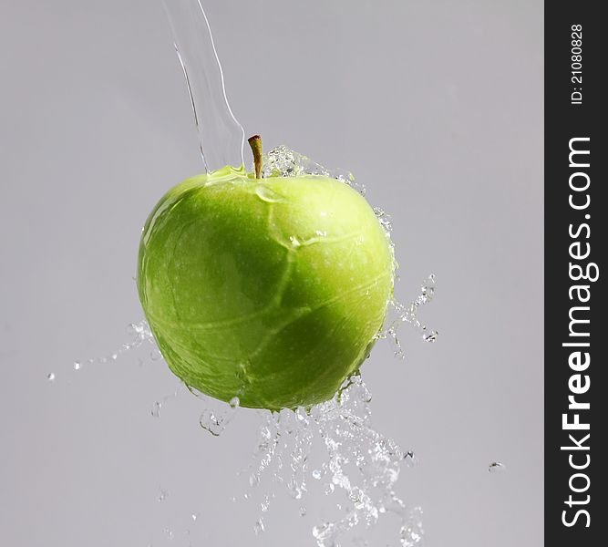 Green Apple In A Waterfountain