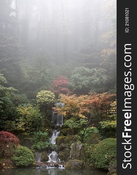 Waterfall at Japanese Garden in Fall Foggy Morning