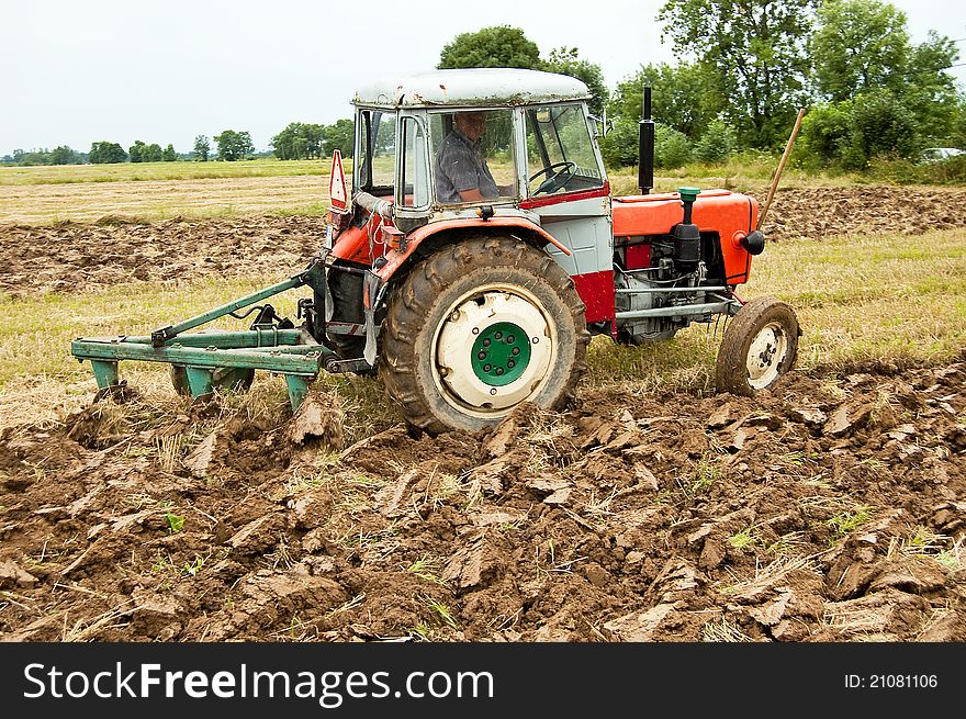 Ploughing field on old tractor in southern Poland